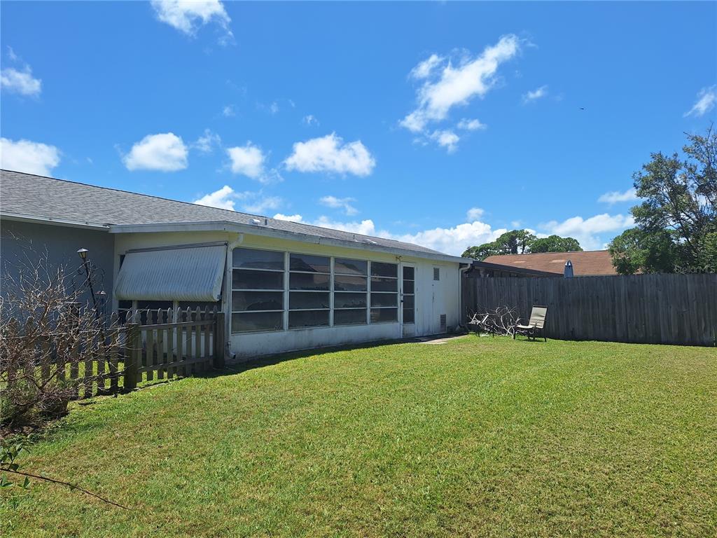 419 Falcon Avenue Edgewater, FL 32141 - Photo 6 of 8 a view of a house with a yard and pathway