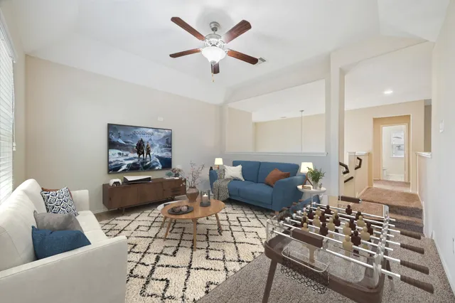 a living room with furniture and wooden floor