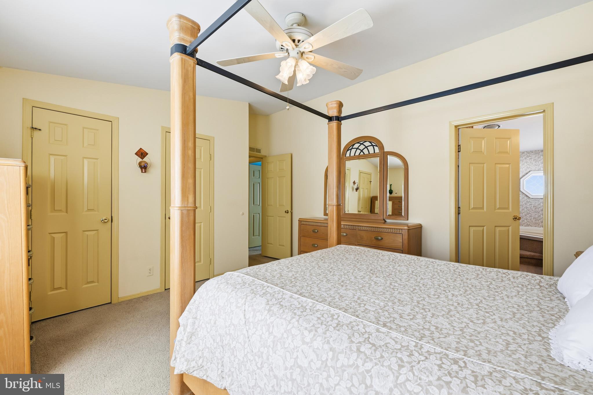 524 Butternut Court New Hope, PA 18938 - Photo 21 of 26 a bedroom with a large bed a mirror and vanity