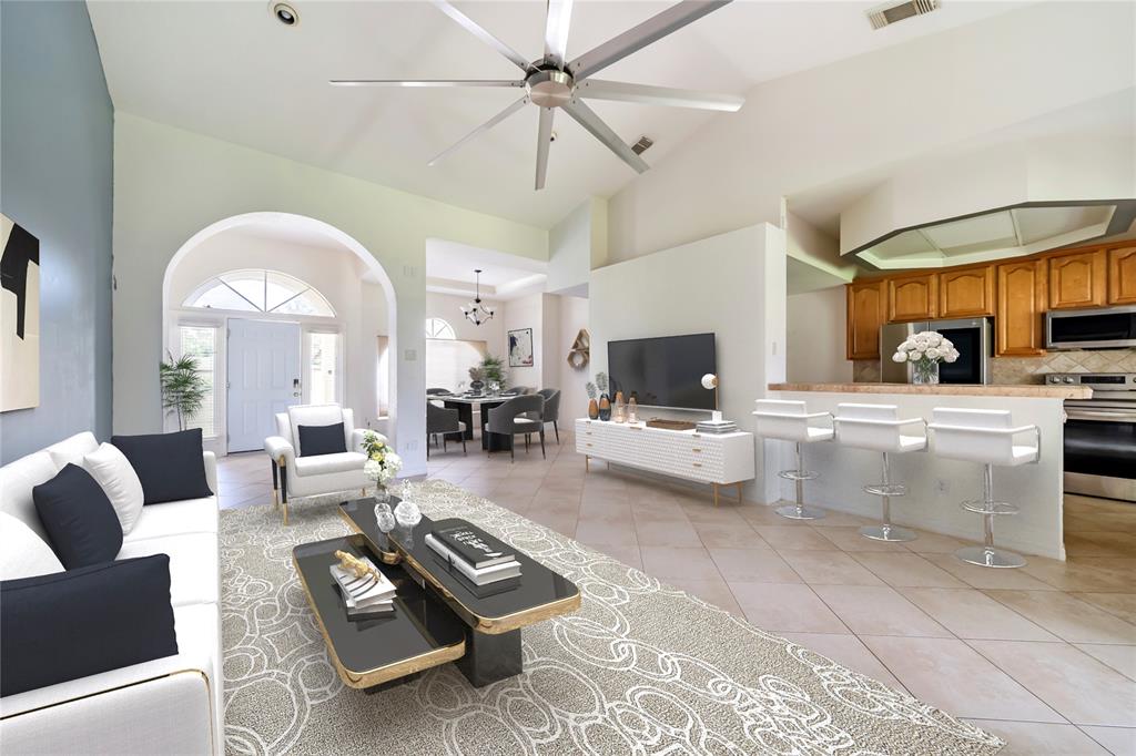 a living room with furniture a flat screen tv and a large window