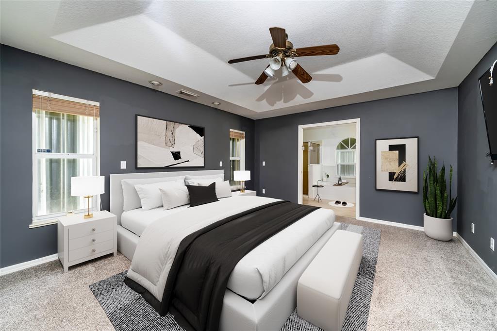 7205 Hibiscus Road Fort Pierce, FL 34951 - Photo 12 of 18 a bedroom with a large bed and a chandelier