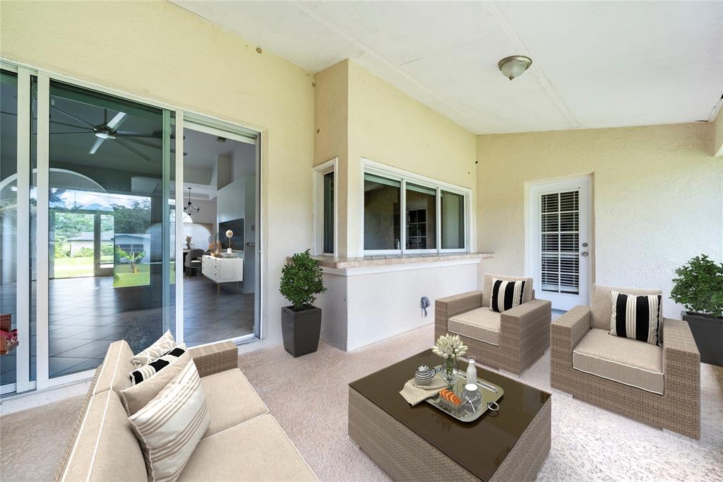 7205 Hibiscus Road Fort Pierce, FL 34951 - Photo 16 of 18 a living room with furniture and a large window