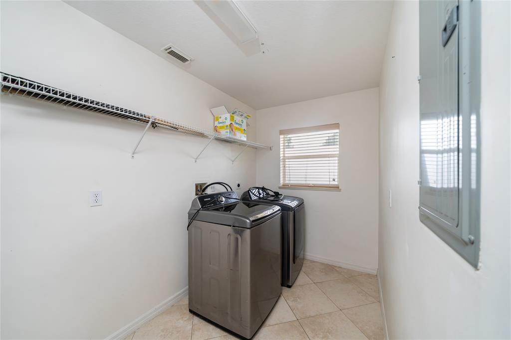 7205 Hibiscus Road Fort Pierce, FL 34951 - Photo 17 of 18 a utility room with a stove a washer and dryer