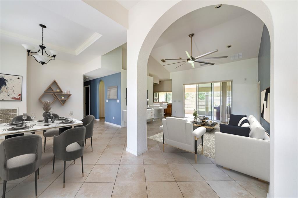 7205 Hibiscus Road Fort Pierce, FL 34951 - Photo 7 of 18 a living room with furniture a table and chairs