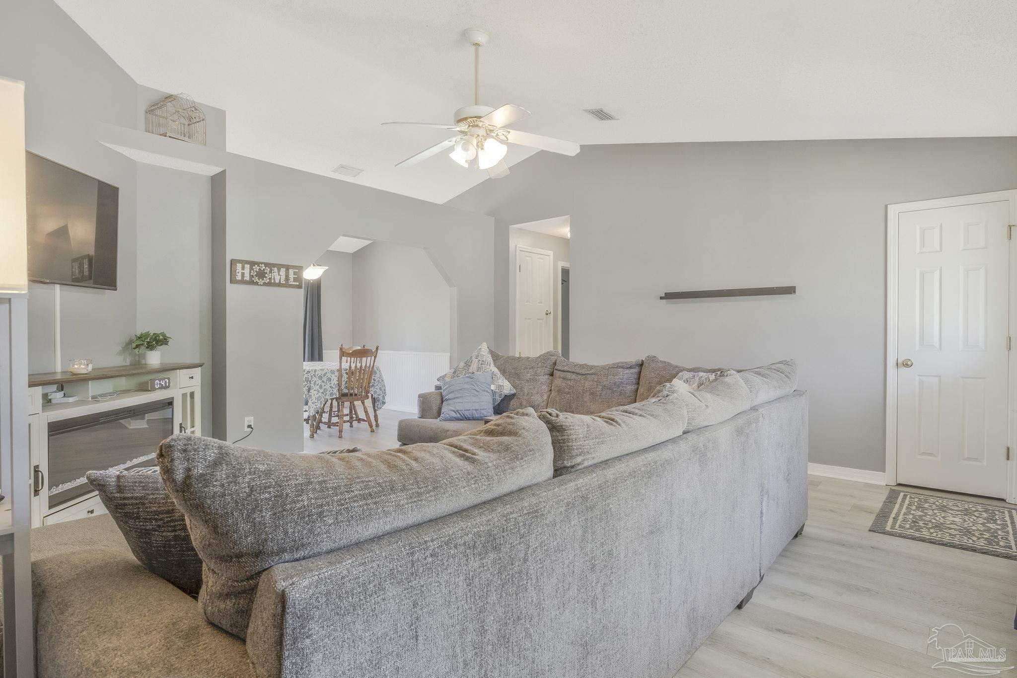5539 Windrun Place Pace, FL 32571 - Photo 13 of 62 a living room with furniture and a chandelier