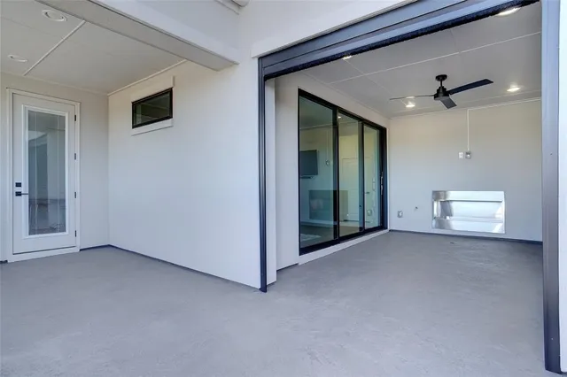 a living room with furniture a chandelier and a kitchen view