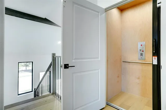 a view of a hallway with wooden floor and entryway