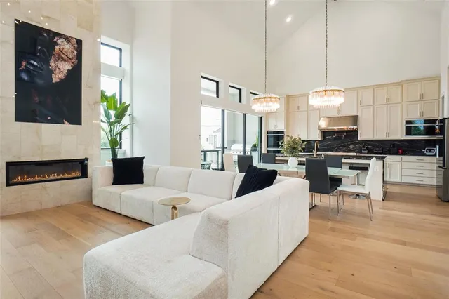 a kitchen with stainless steel appliances granite countertop a stove a sink and white cabinets