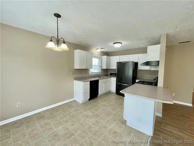 a kitchen with kitchen island sink stainless steel appliances and cabinets
