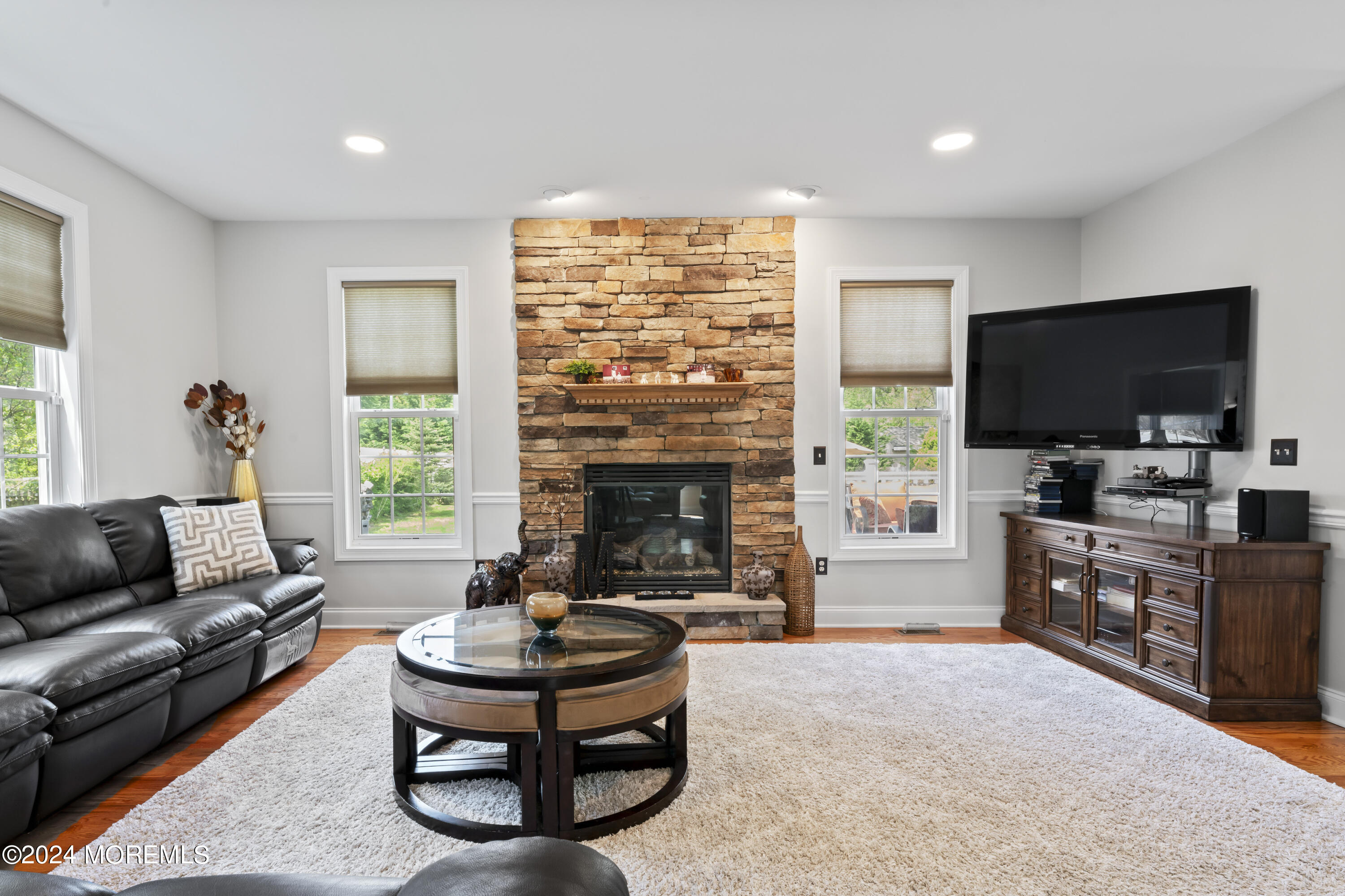 1588 West Front Street Lincroft, NJ 07738 - Photo 12 of 50 a living room with furniture a flat screen tv and a fireplace