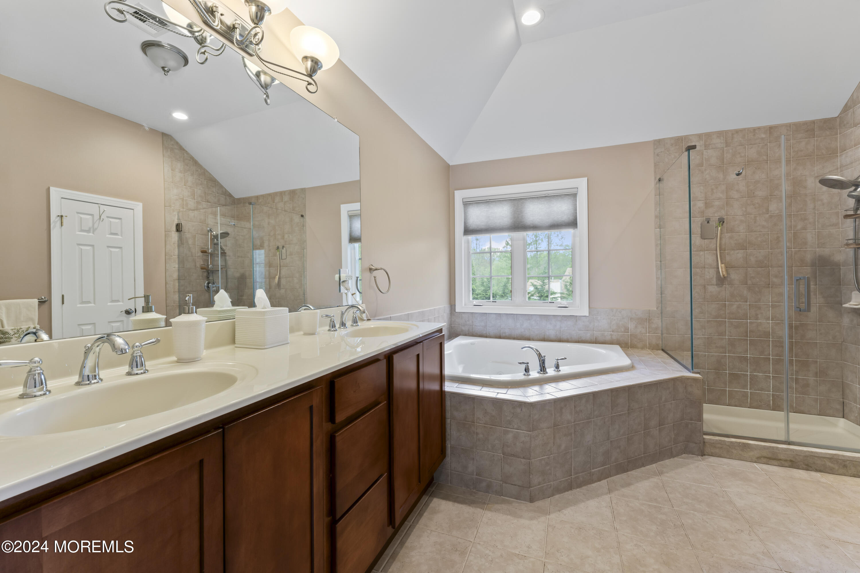 1588 West Front Street Lincroft, NJ 07738 - Photo 25 of 50 a spacious bathroom with a bathtub a sink a mirror a shower and a window