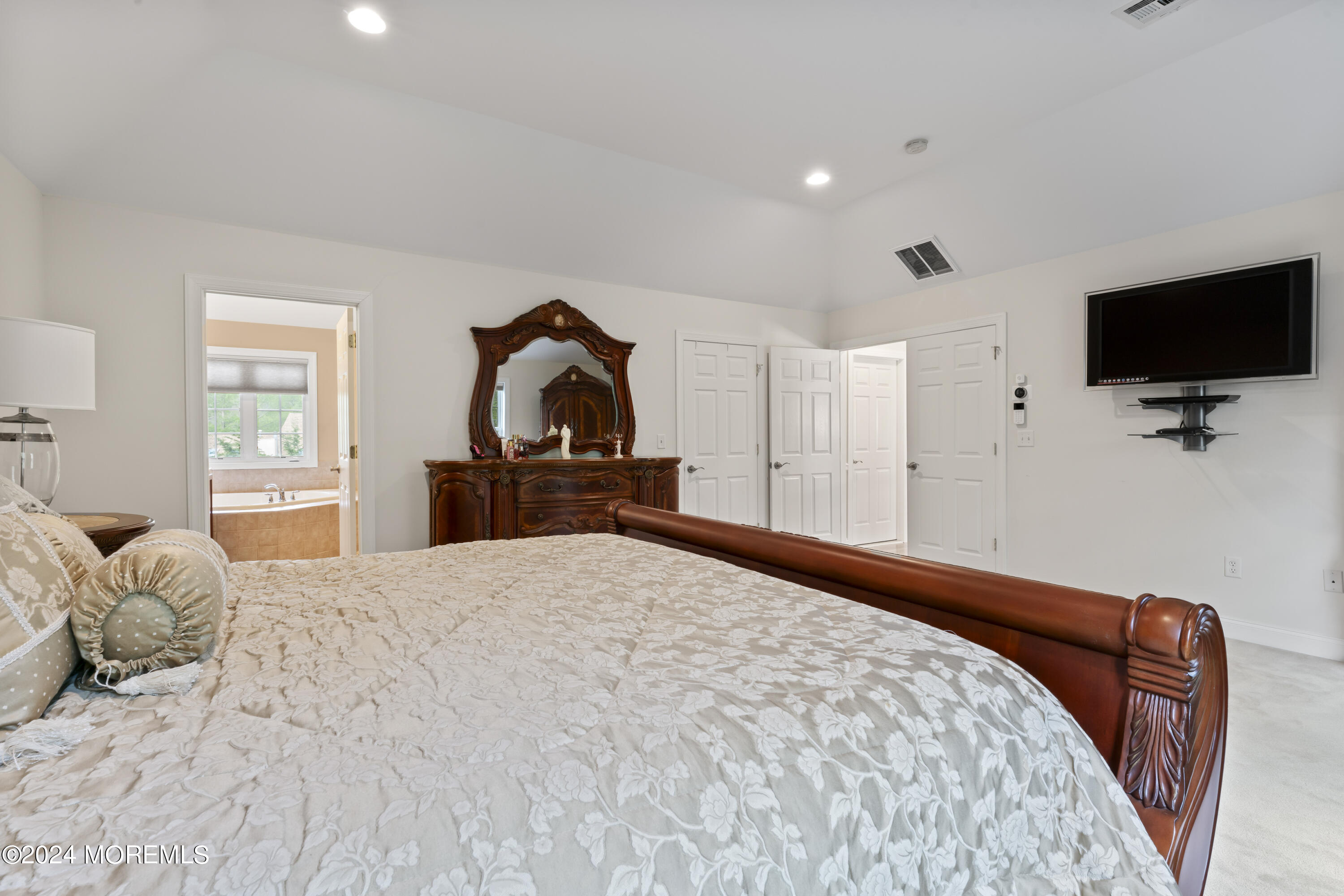 1588 West Front Street Lincroft, NJ 07738 - Photo 27 of 50 a bedroom with a bed and a flat screen tv