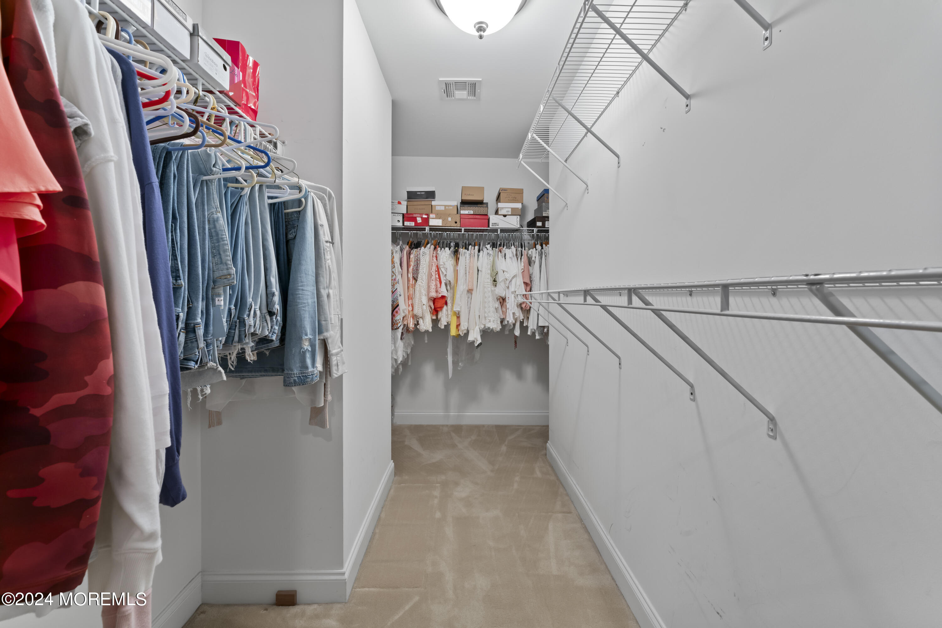 1588 West Front Street Lincroft, NJ 07738 - Photo 29 of 50 a view of walk in closet with clothes and shoes