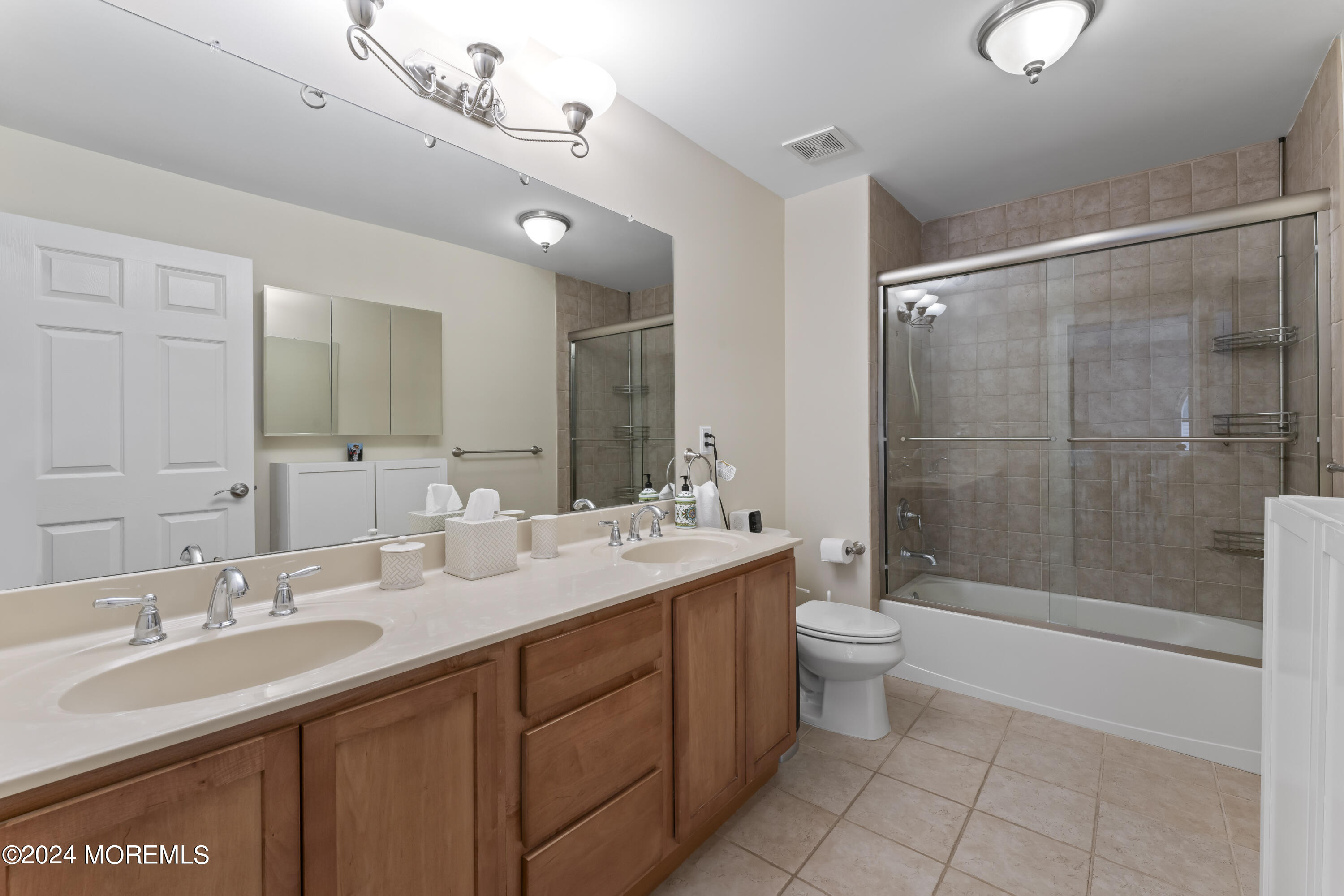 1588 West Front Street Lincroft, NJ 07738 - Photo 32 of 50 a bathroom with a double vanity sink mirror and toilet