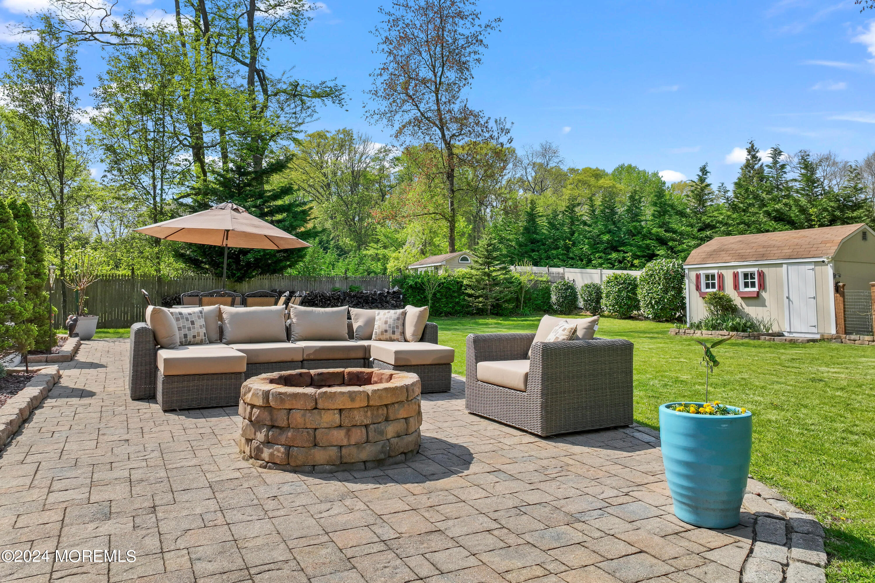 1588 West Front Street Lincroft, NJ 07738 - Photo 42 of 50 a view of a patio with fire pit