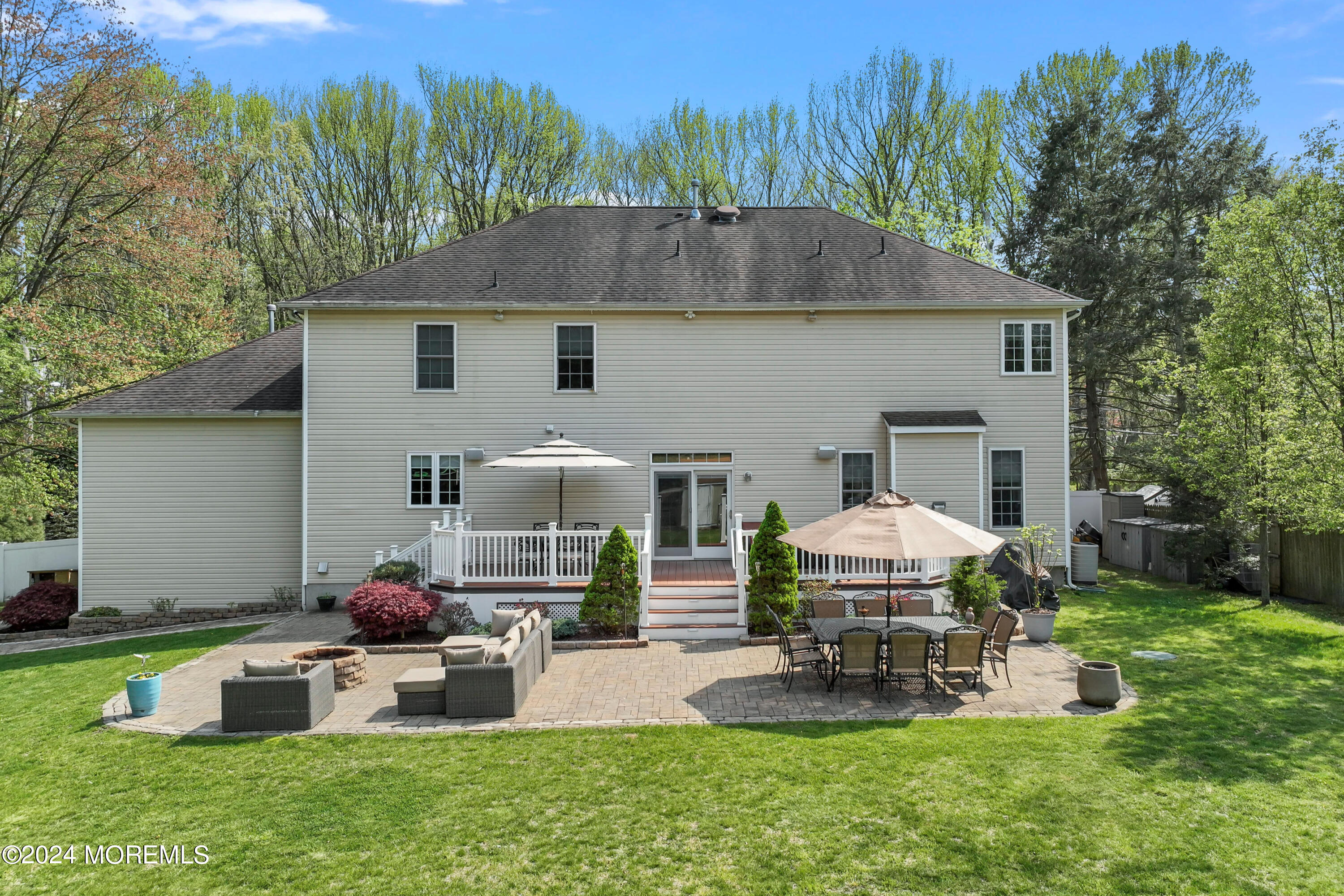 1588 West Front Street Lincroft, NJ 07738 - Photo 43 of 50 a backyard of a house with table and chairs