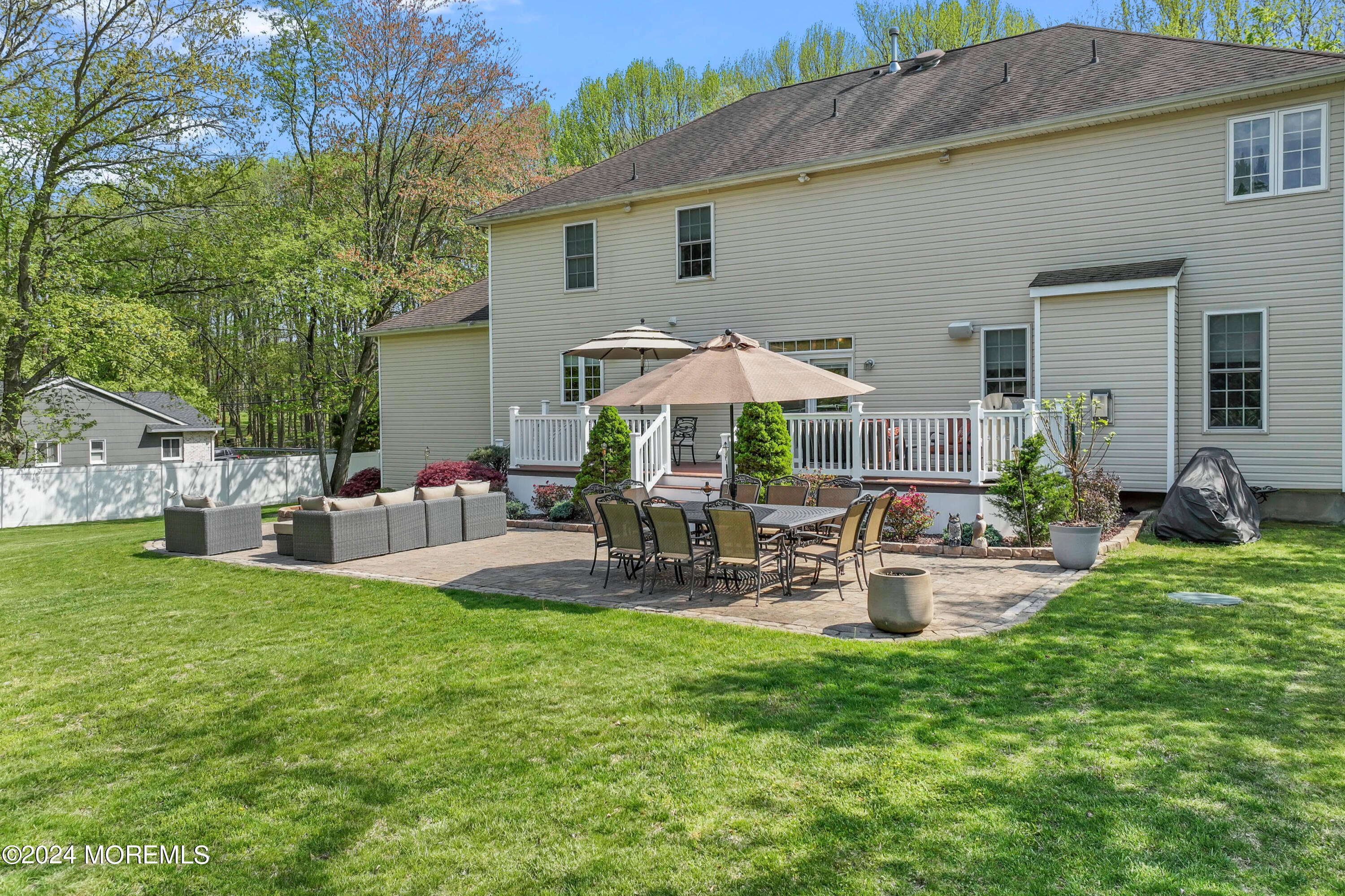 1588 West Front Street Lincroft, NJ 07738 - Photo 44 of 50 a view of backyard of house with outdoor seating and green space