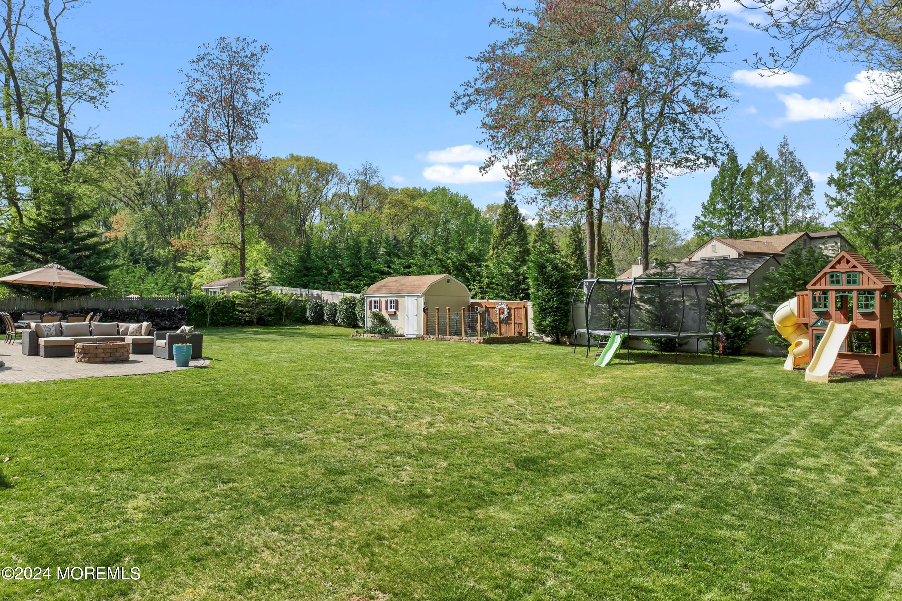 1588 West Front Street Lincroft, NJ 07738 - Photo 45 of 50 a view of a garden with a bench in the garden