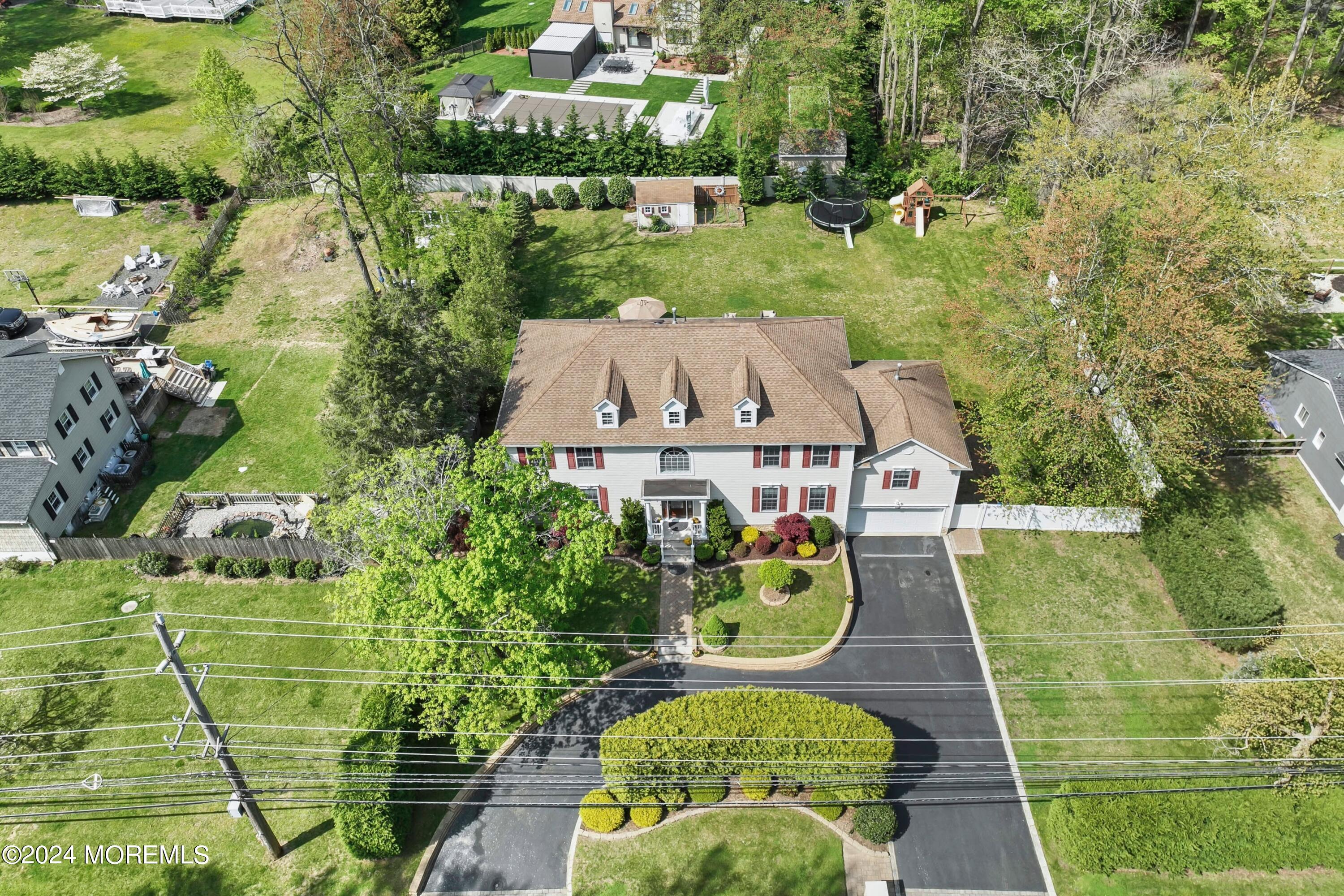 1588 West Front Street Lincroft, NJ 07738 - Photo 47 of 50 an aerial view of a house with a garden