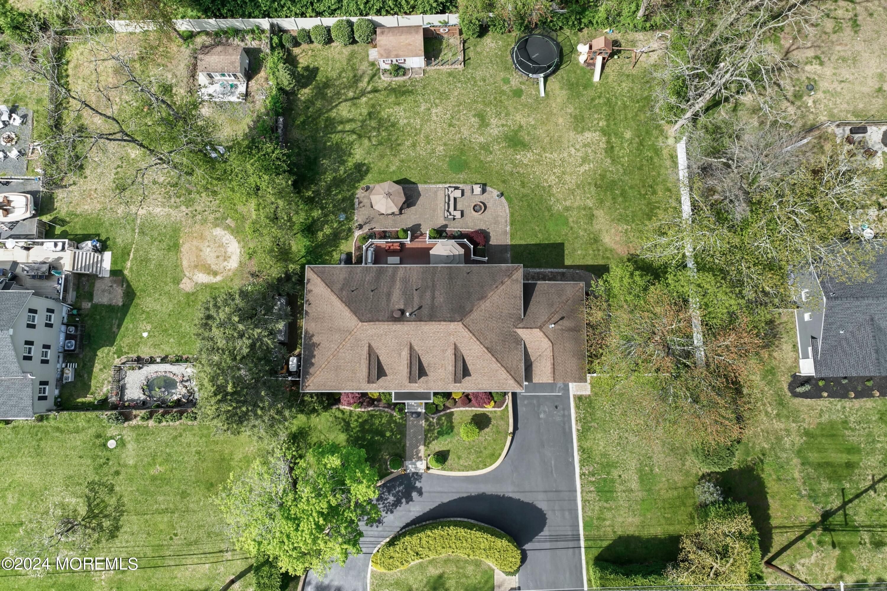 1588 West Front Street Lincroft, NJ 07738 - Photo 48 of 50 an aerial view of a house with outdoor space pool seating area and yard