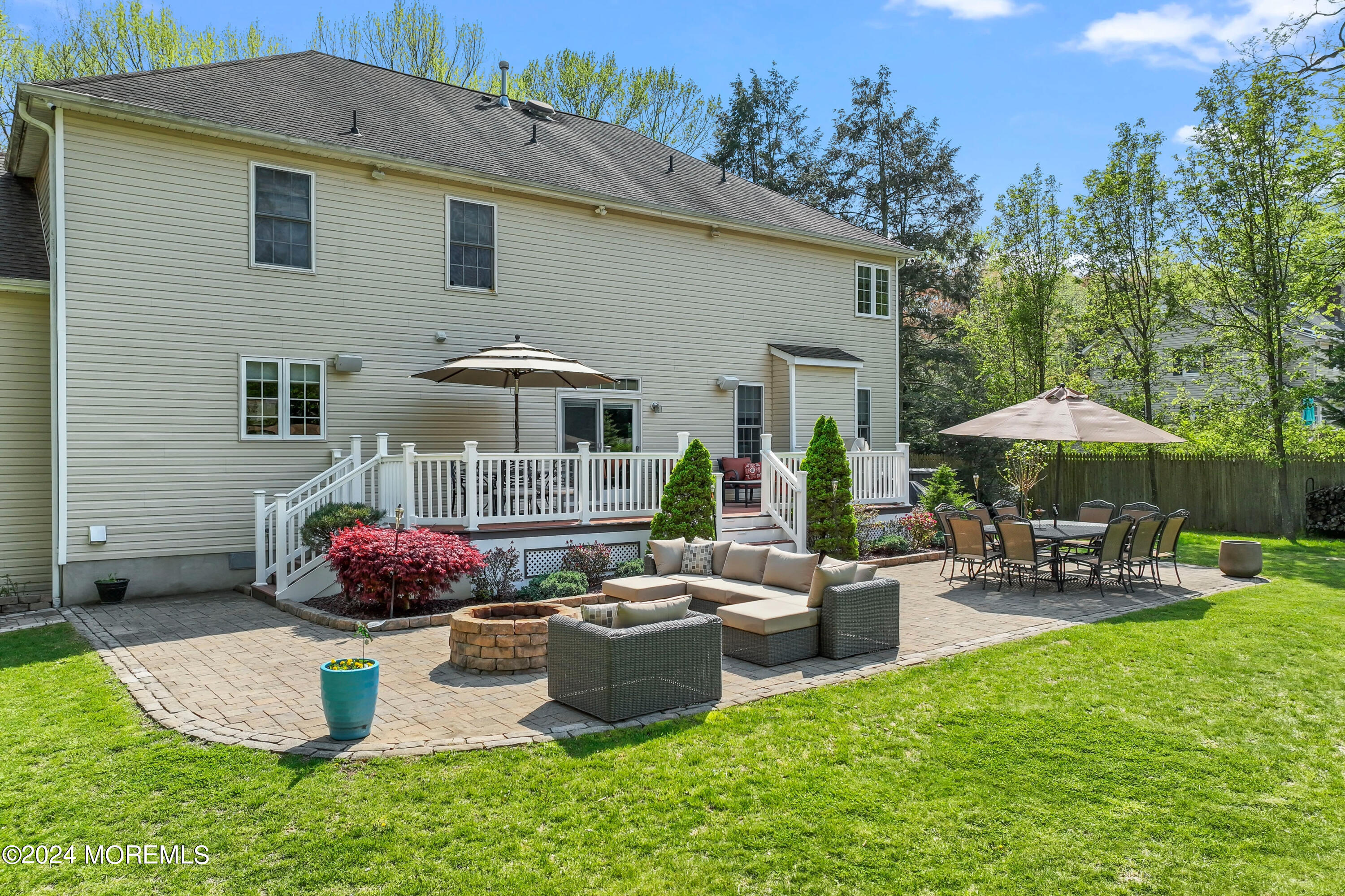1588 West Front Street Lincroft, NJ 07738 - Photo 5 of 50 a backyard of a house with table and chairs