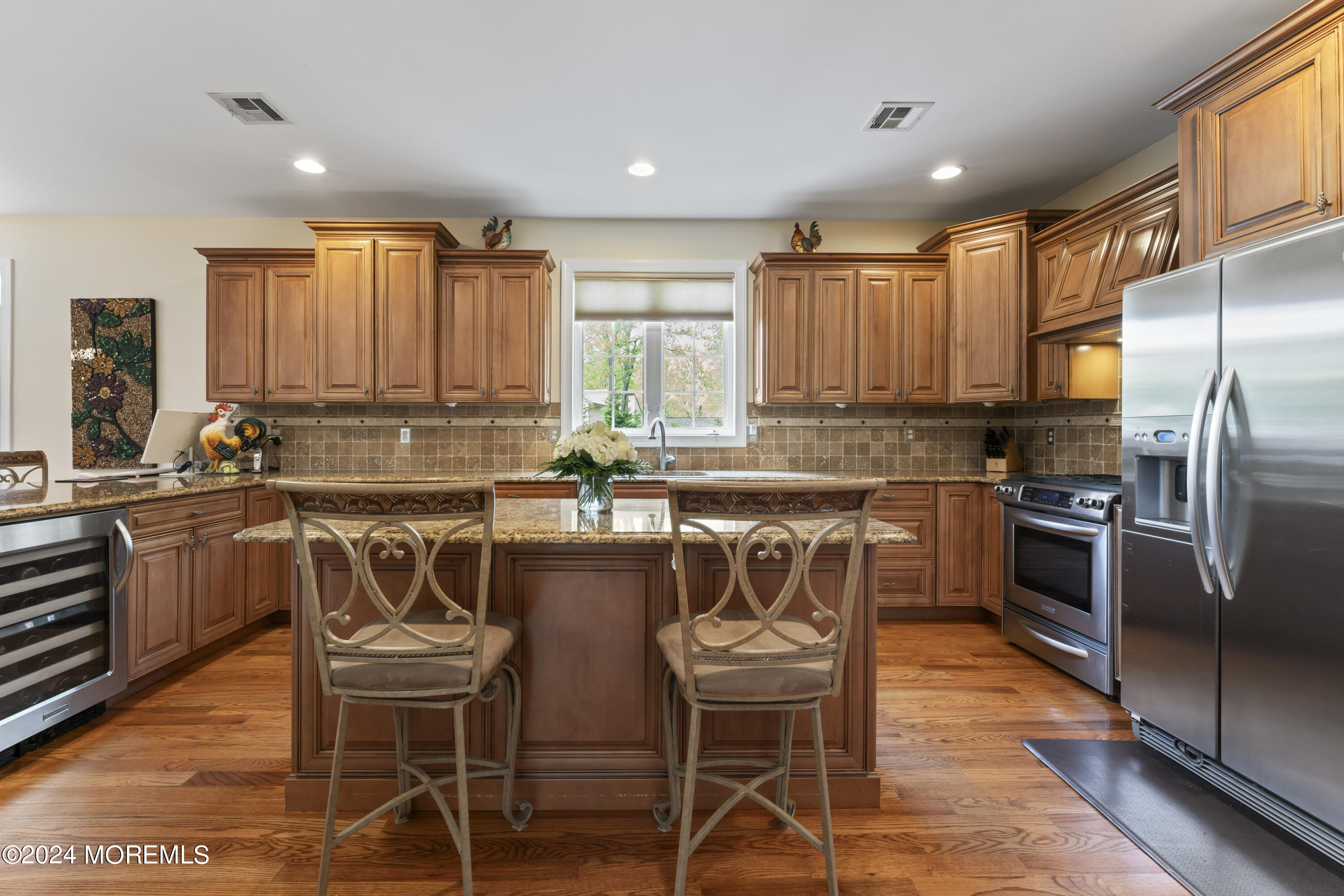 1588 West Front Street Lincroft, NJ 07738 - Photo 7 of 50 a kitchen with a table chairs microwave and refrigerator