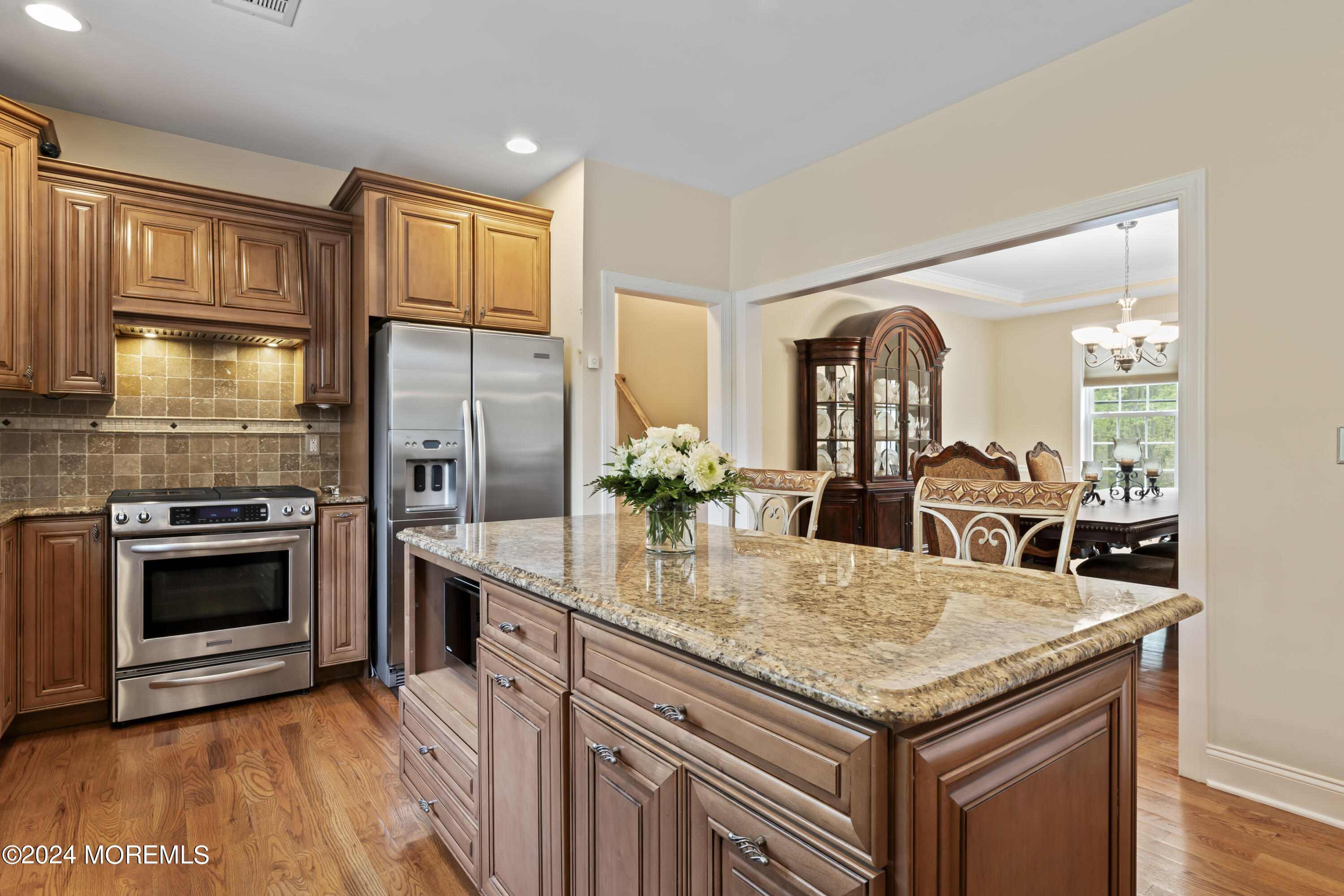 1588 West Front Street Lincroft, NJ 07738 - Photo 9 of 50 a kitchen with granite countertop stainless steel appliances and wooden cabinets
