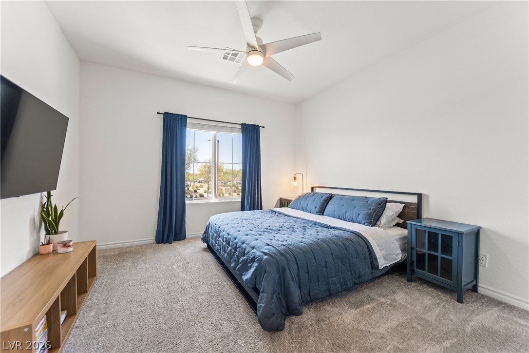 7204 North Decatur Boulevard, Unit 5 North Las Vegas, NV 89084 - Photo 10 of 34 Plush carpeting anchors this relaxing bedroom filled with soft natural light.