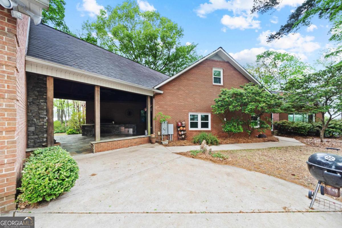 390 David Williams Road Sparta, GA 31087 - Photo 11 of 73 a backyard of a house with outdoor seating and trees