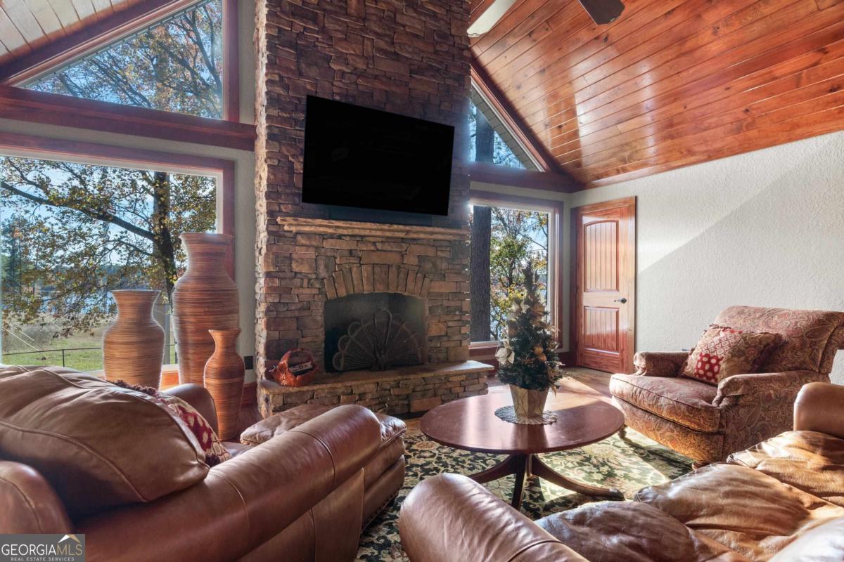 390 David Williams Road Sparta, GA 31087 - Photo 29 of 73 a living room with fireplace furniture and a flat screen tv