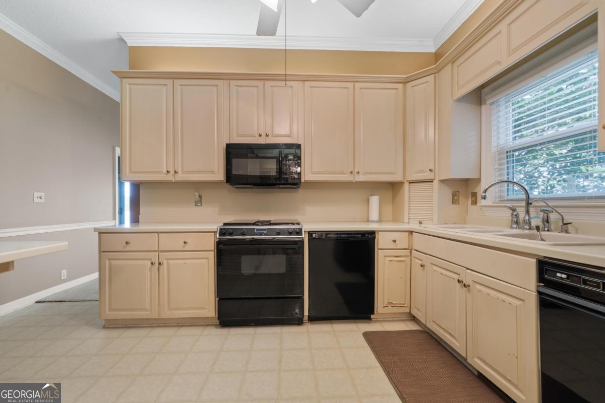 390 David Williams Road Sparta, GA 31087 - Photo 35 of 73 a kitchen with stainless steel appliances granite countertop a stove sink and cabinets