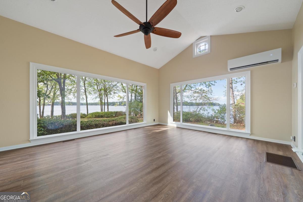 390 David Williams Road Sparta, GA 31087 - Photo 36 of 73 a view of empty room with wooden floor and fan