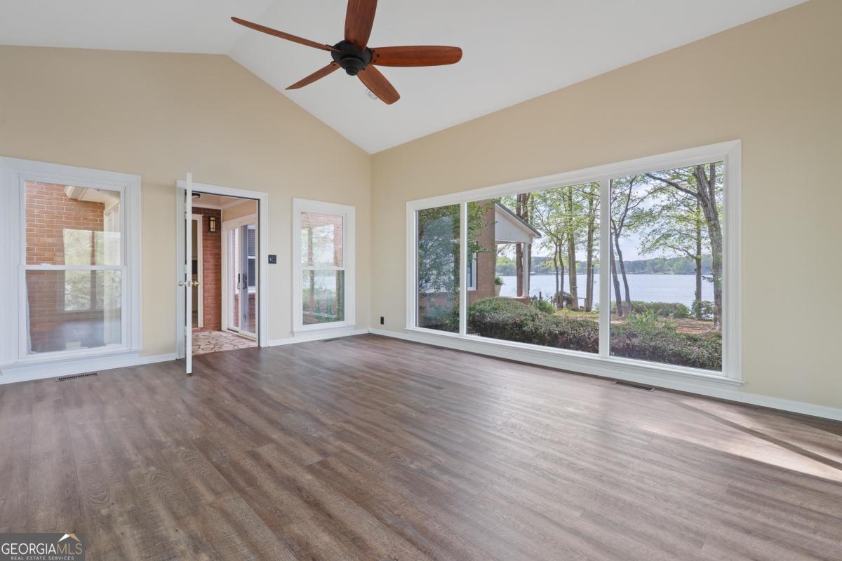 390 David Williams Road Sparta, GA 31087 - Photo 37 of 73 a view of empty room with wooden floor and fan