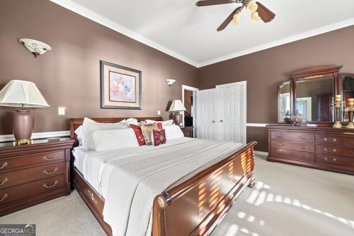 390 David Williams Road Sparta, GA 31087 - Photo 38 of 73 a bedroom with a bed and a chandelier