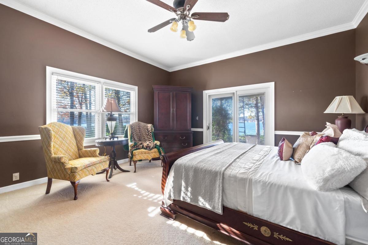 390 David Williams Road Sparta, GA 31087 - Photo 39 of 73 a bedroom with a bed chairs and two large window