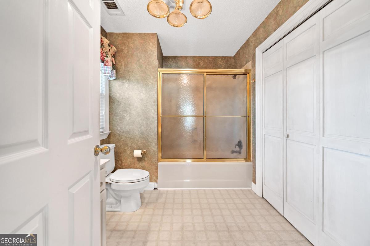 390 David Williams Road Sparta, GA 31087 - Photo 44 of 73 a bathroom with a toilet and a shower