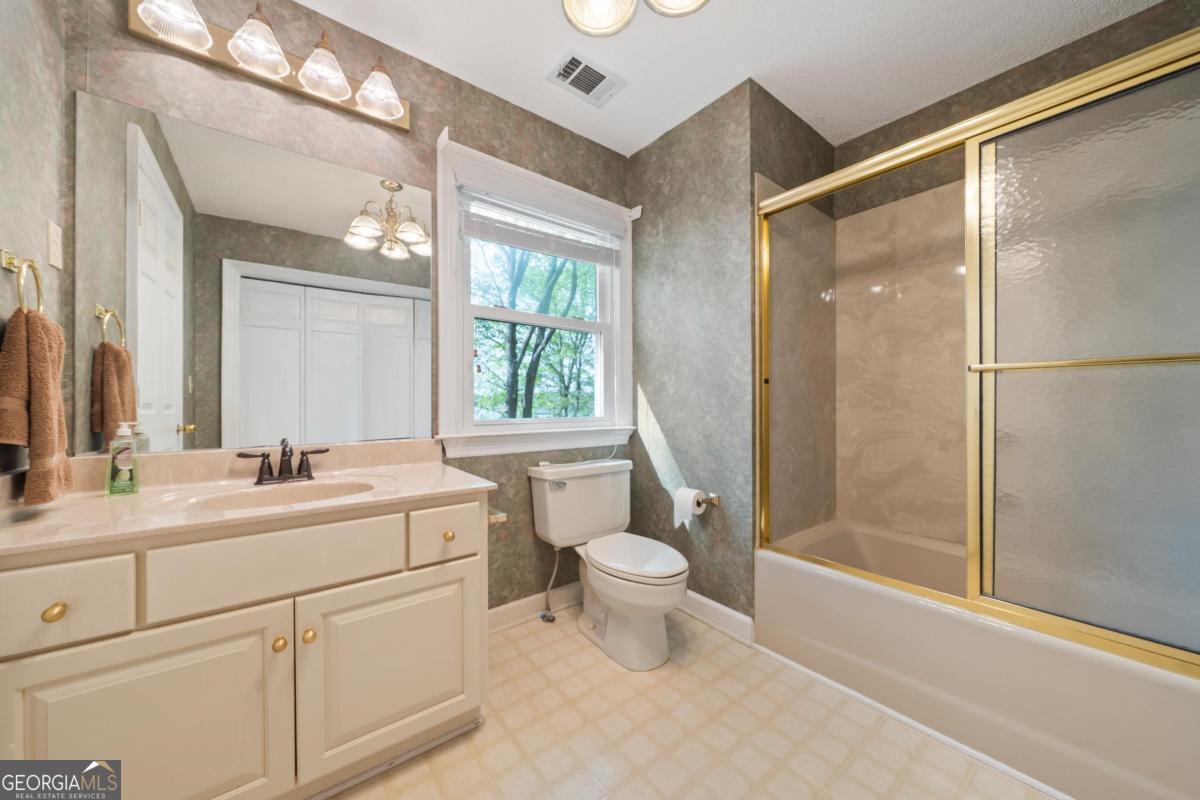 390 David Williams Road Sparta, GA 31087 - Photo 45 of 73 a bathroom with a double vanity sink toilet mirror and shower