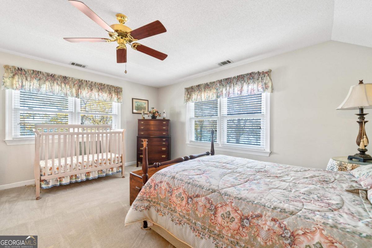 390 David Williams Road Sparta, GA 31087 - Photo 46 of 73 a bed sitting in a spacious bedroom next to a window