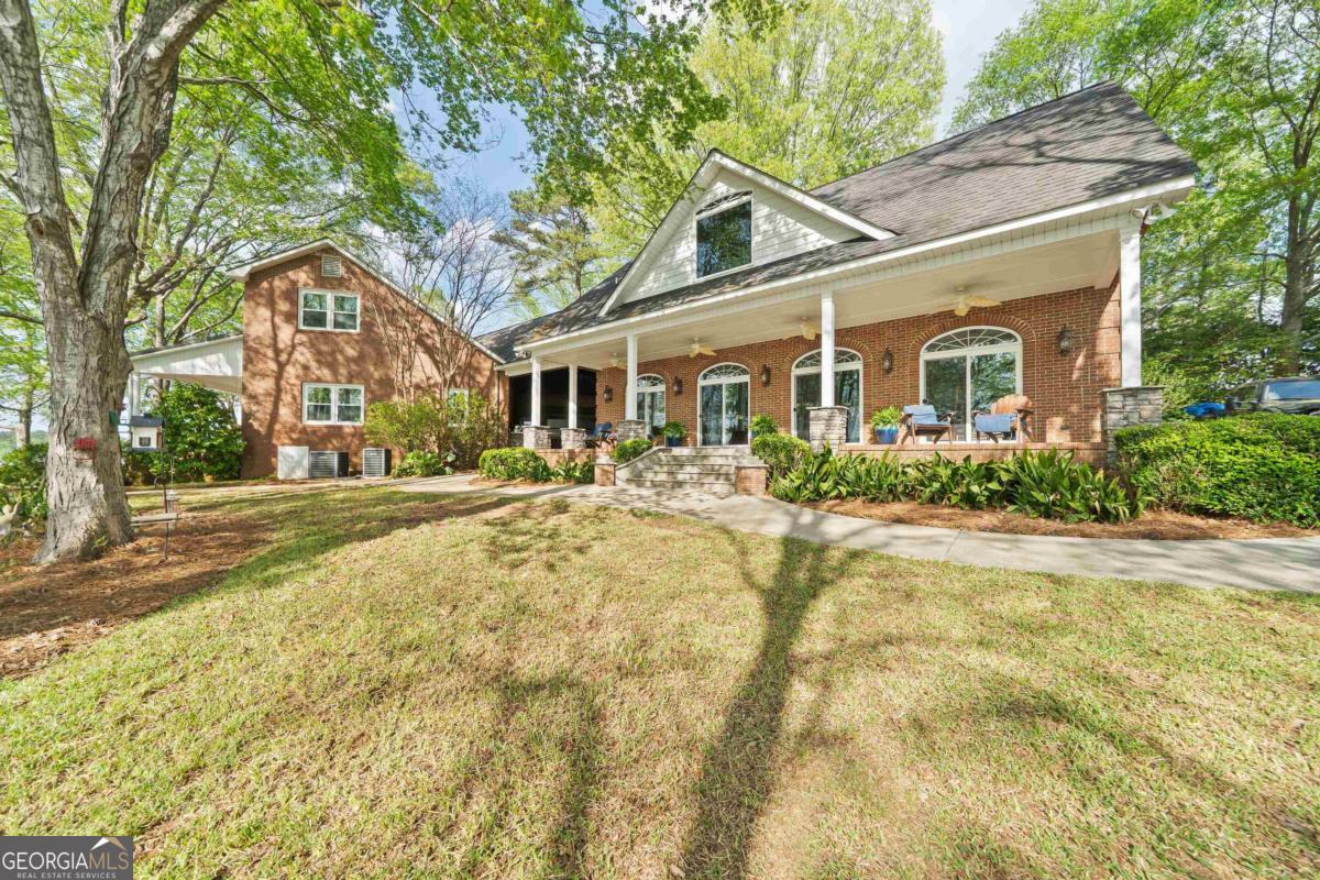 390 David Williams Road Sparta, GA 31087 - Photo 5 of 73 a front view of a house with a yard