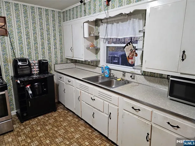 a kitchen with stainless steel appliances a sink and a stove