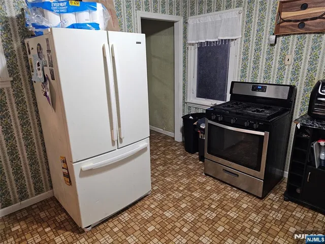 a stove top oven sitting inside of a kitchen