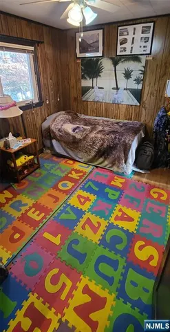 a bed room with two beds and next to a window