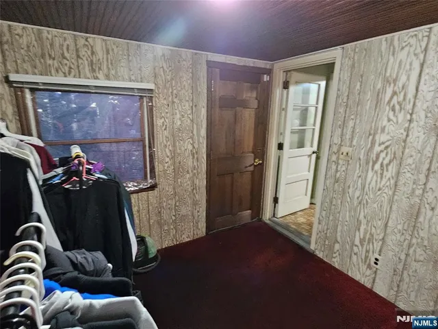 a bedroom with a bed and a mirror