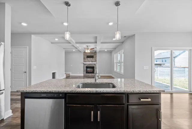 a kitchen with granite countertop a sink and center island