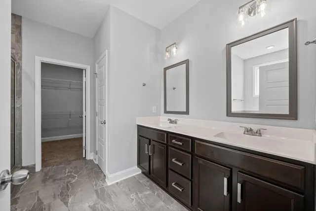 a bathroom with a double vanity sink and mirror