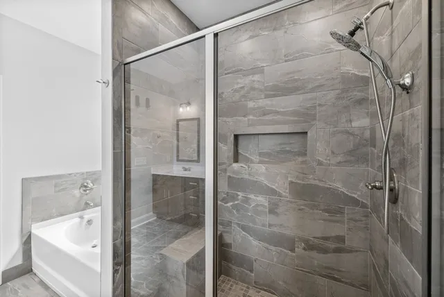 a bathroom with a bathtub and shower