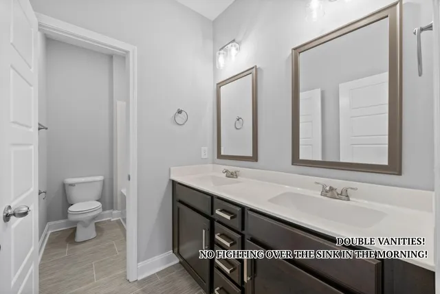 a bathroom with a sink a toilet and a mirror