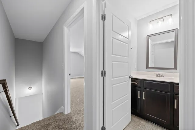 a bathroom with a sink a toilet and mirror