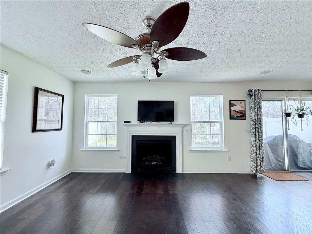 5705 Mountain Top Place Cumming, GA 30041 - Photo 4 of 10 a living room with furniture fireplace and flat screen tv