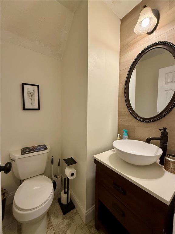 5705 Mountain Top Place Cumming, GA 30041 - Photo 7 of 10 a bathroom with a toilet a sink and mirror